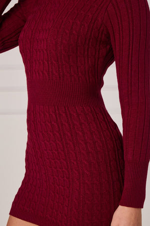 Close-up of cable-knit texture on long sleeve mini dress, deep red/burgundy