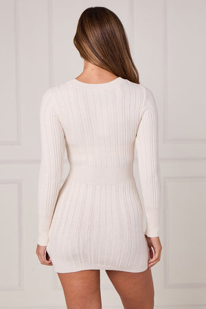 Cream cable-knit mini dress with long sleeves, back view with fitted waist
