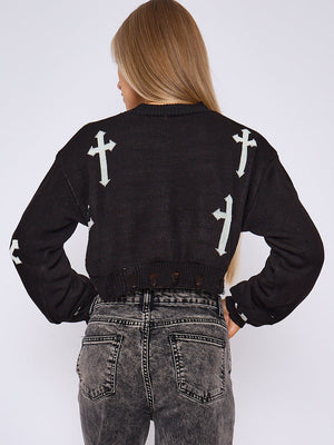 Black knitted crop jumper shown from back with white cross print and frayed hem