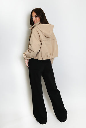 Beige cropped hooded jacket with front zipper and gathered waist