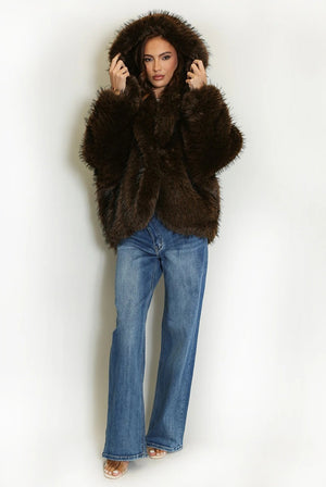 Dark brown shaggy fur coat with its oversized hood raised