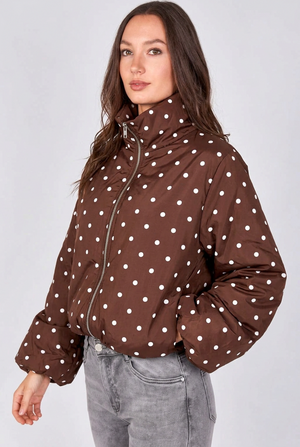 Brown lightweight jacket with white polka dots, high collar, zip front, and gathered cuffs