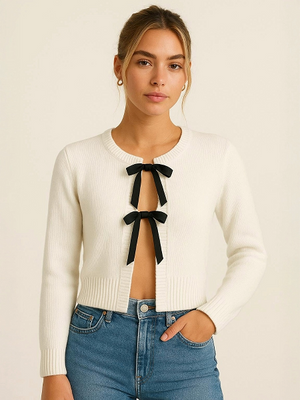 Light grey knitted lace-up cardigan with black bow ties at center front, long sleeves