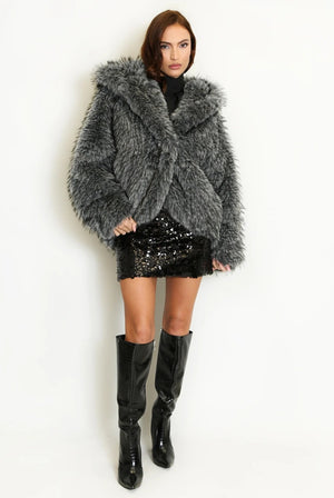 Full-length view of a grey shaggy fur coat with a wide collar