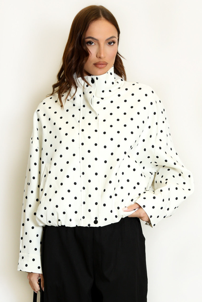 Cream polka dot lightweight jacket with long sleeves, stand collar and zip front