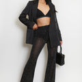 Diamante mesh flare-hem trousers in dark color, allover sparkle finish