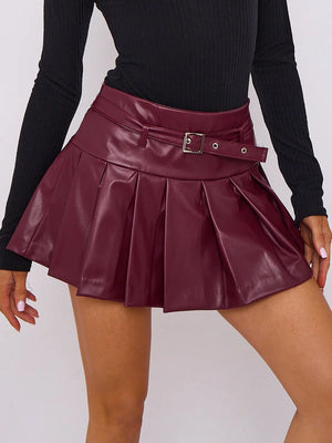 Close-up of wine faux-leather skort with buckle belt and pleats