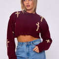 Wine red knitted crop jumper with gold crucifix motifs, long sleeves, ribbed cuffs