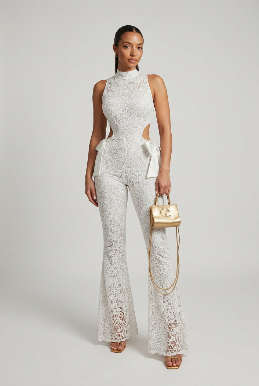 White lace halter jumpsuit with flared bell legs and cut-out sides, satin bow at waist