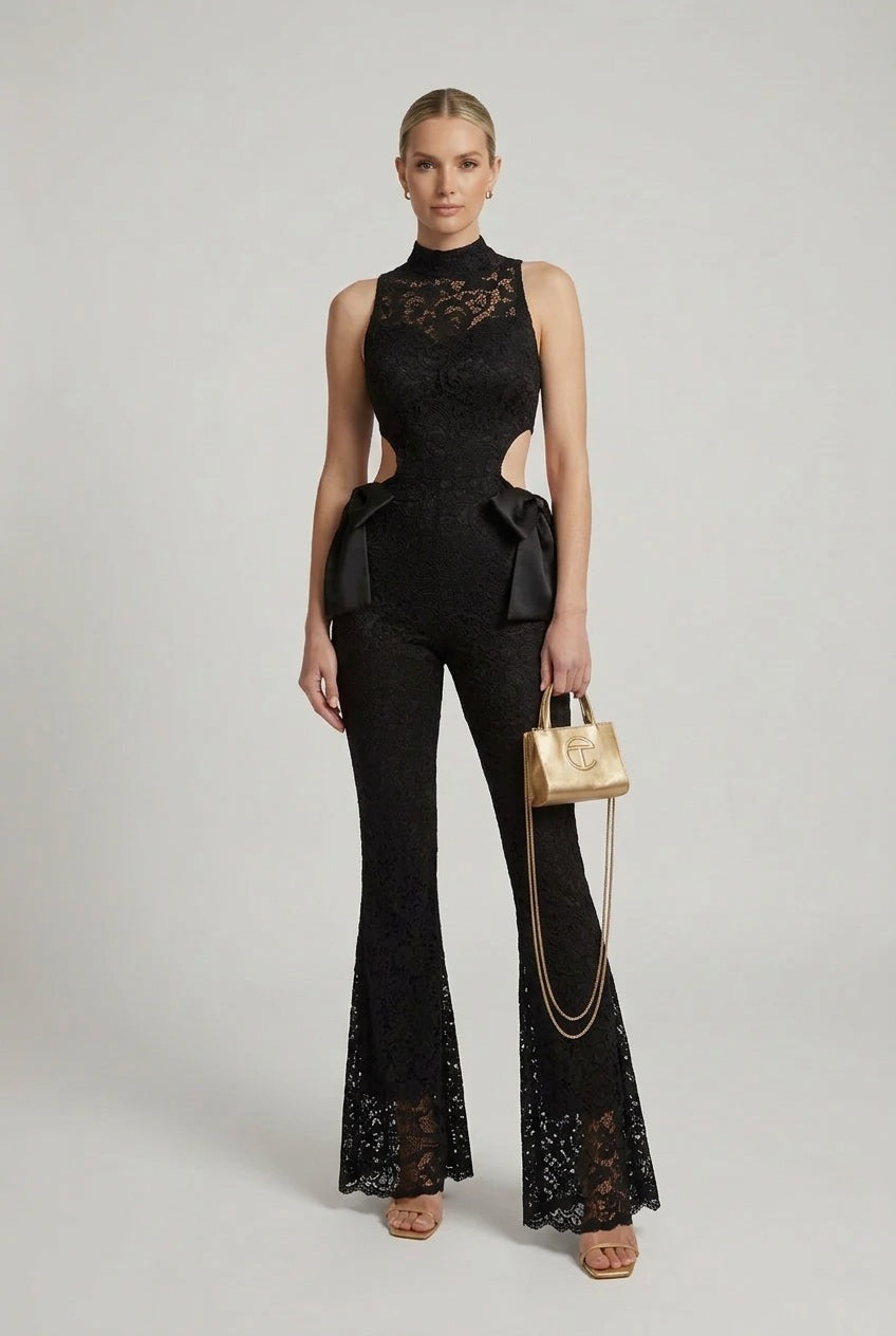 Black lace halter jumpsuit with cut-out waist detail, flared bell legs and bow accents