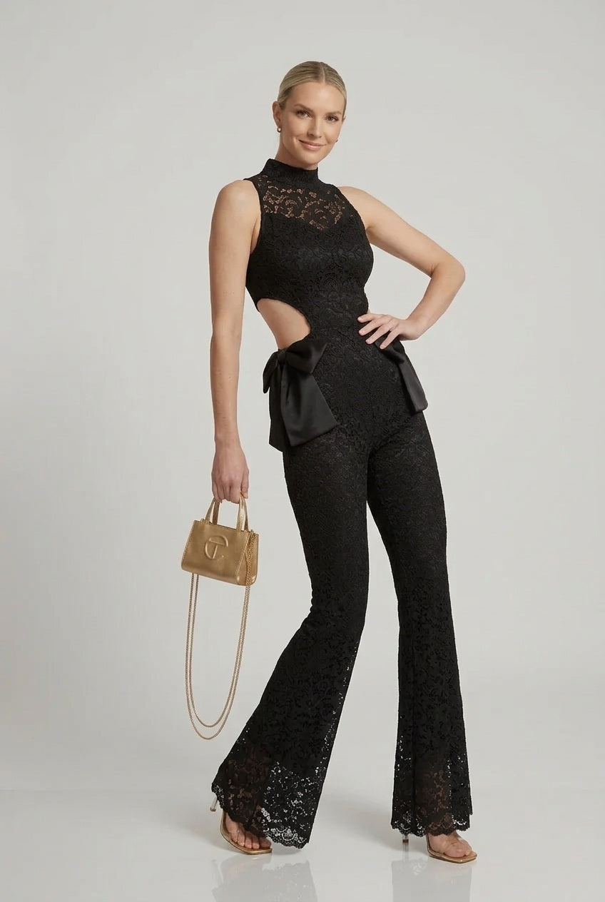 Black lace halter jumpsuit with flared bell legs and waist bow, high neckline