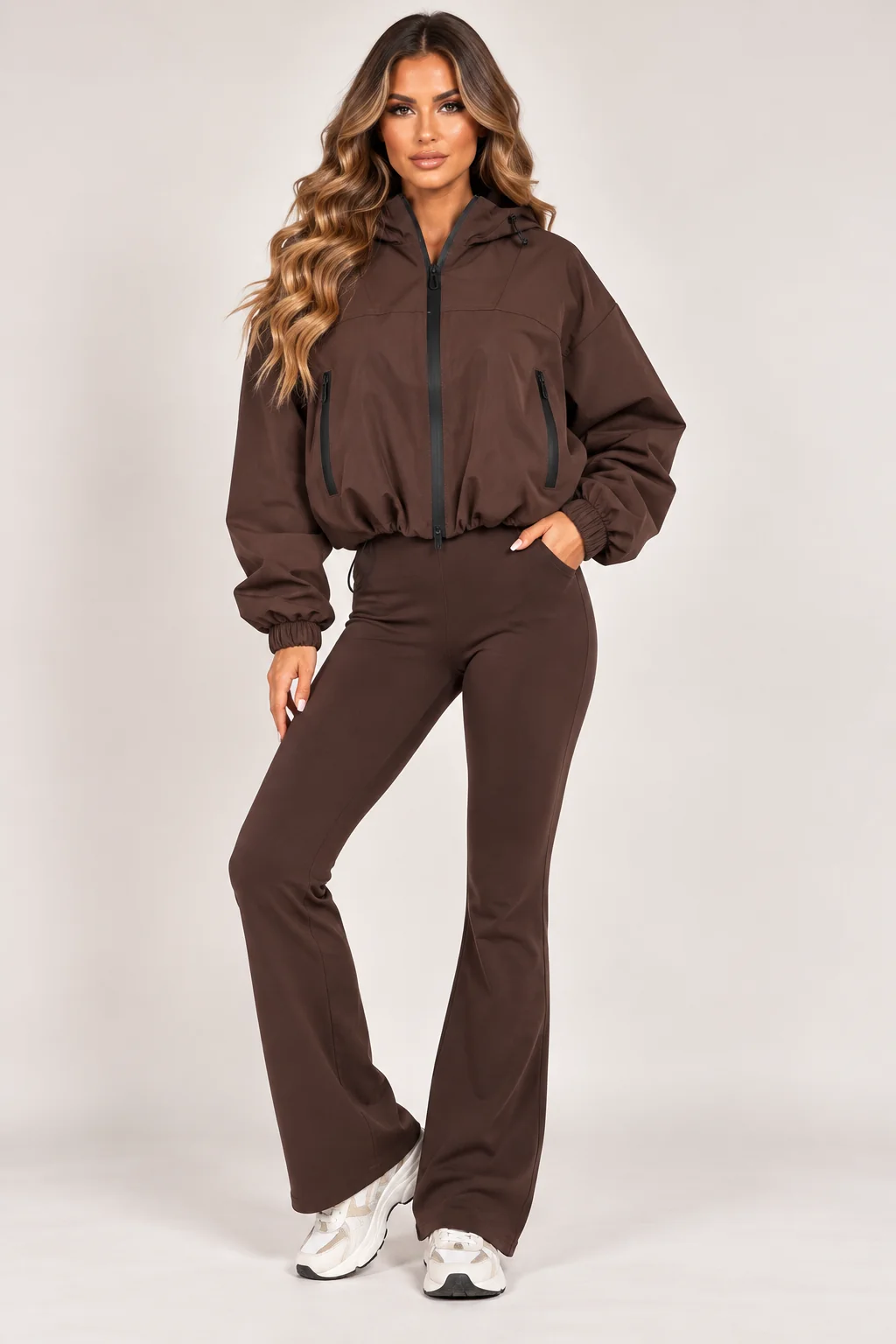 Brown hooded zip-up windbreaker jacket with drawstring waist and zip pockets
