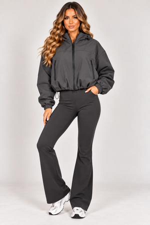 Grey hooded zip-up windbreaker jacket with drawstring waist and zip side pockets