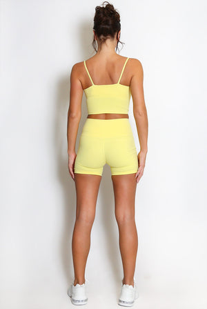 Yellow strappy crop top and matching biker shorts set, back view