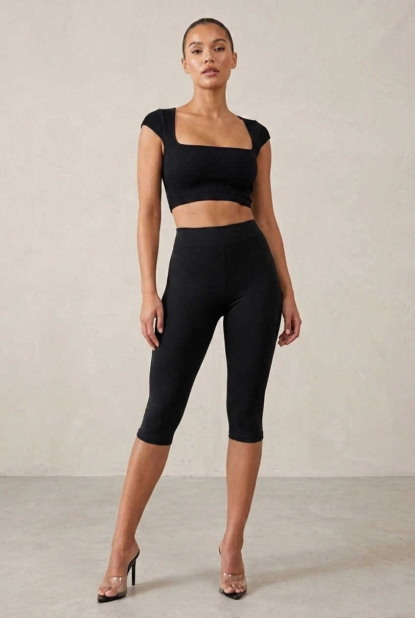 Black Capri leggings shown with a cropped square-neck top.