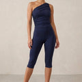 Navy Capri leggings with a close fit, shown with a matching one-shoulder top.