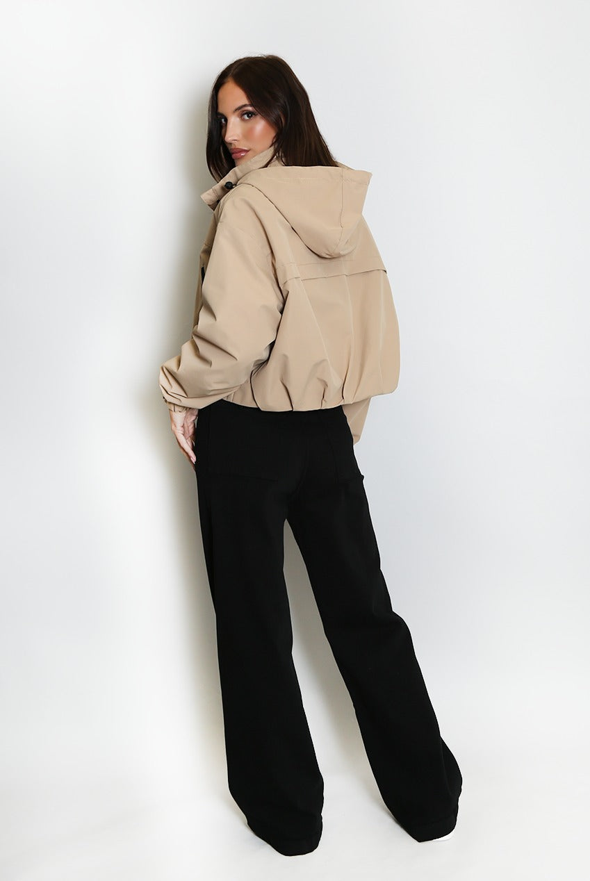 Beige cropped hooded jacket with front zipper and gathered waist