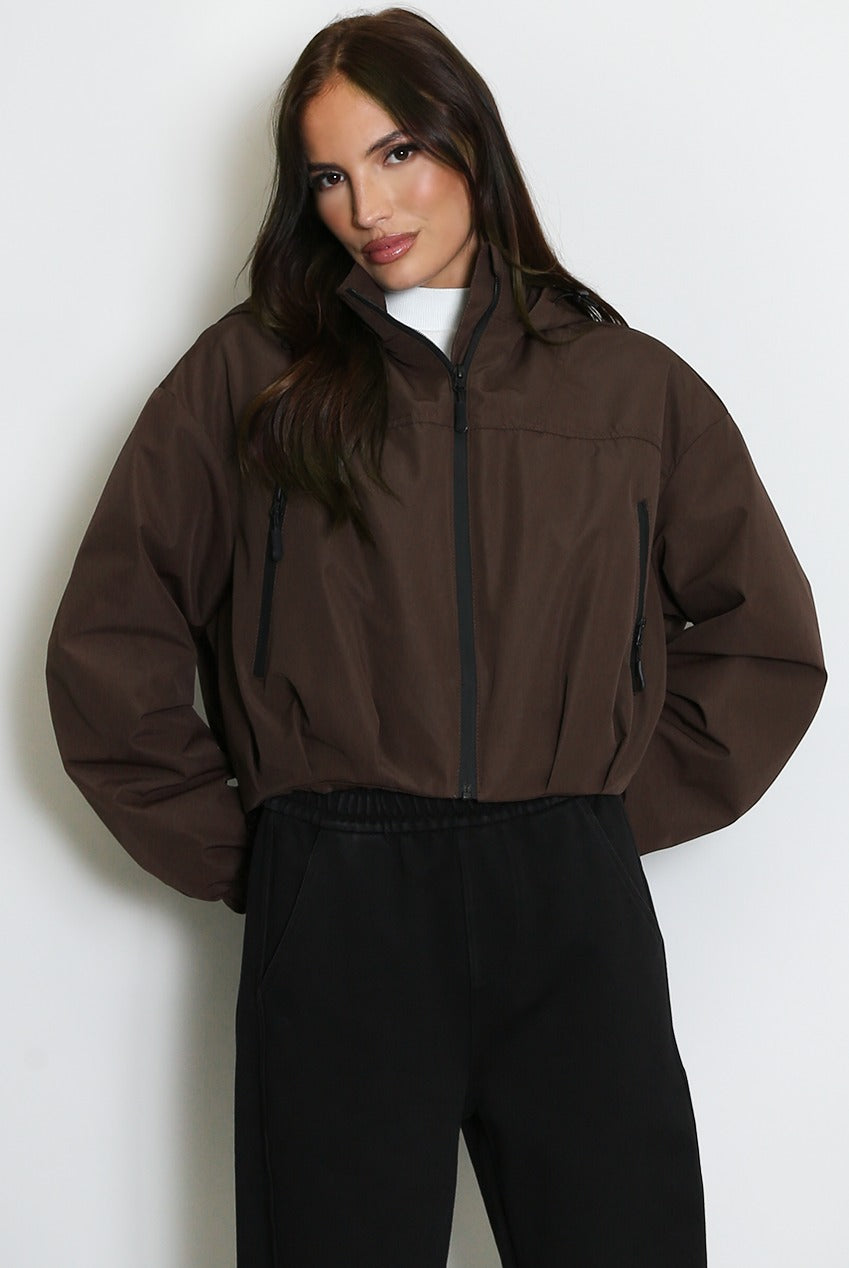 Brown cropped hooded jacket with zip front and side pocket openings