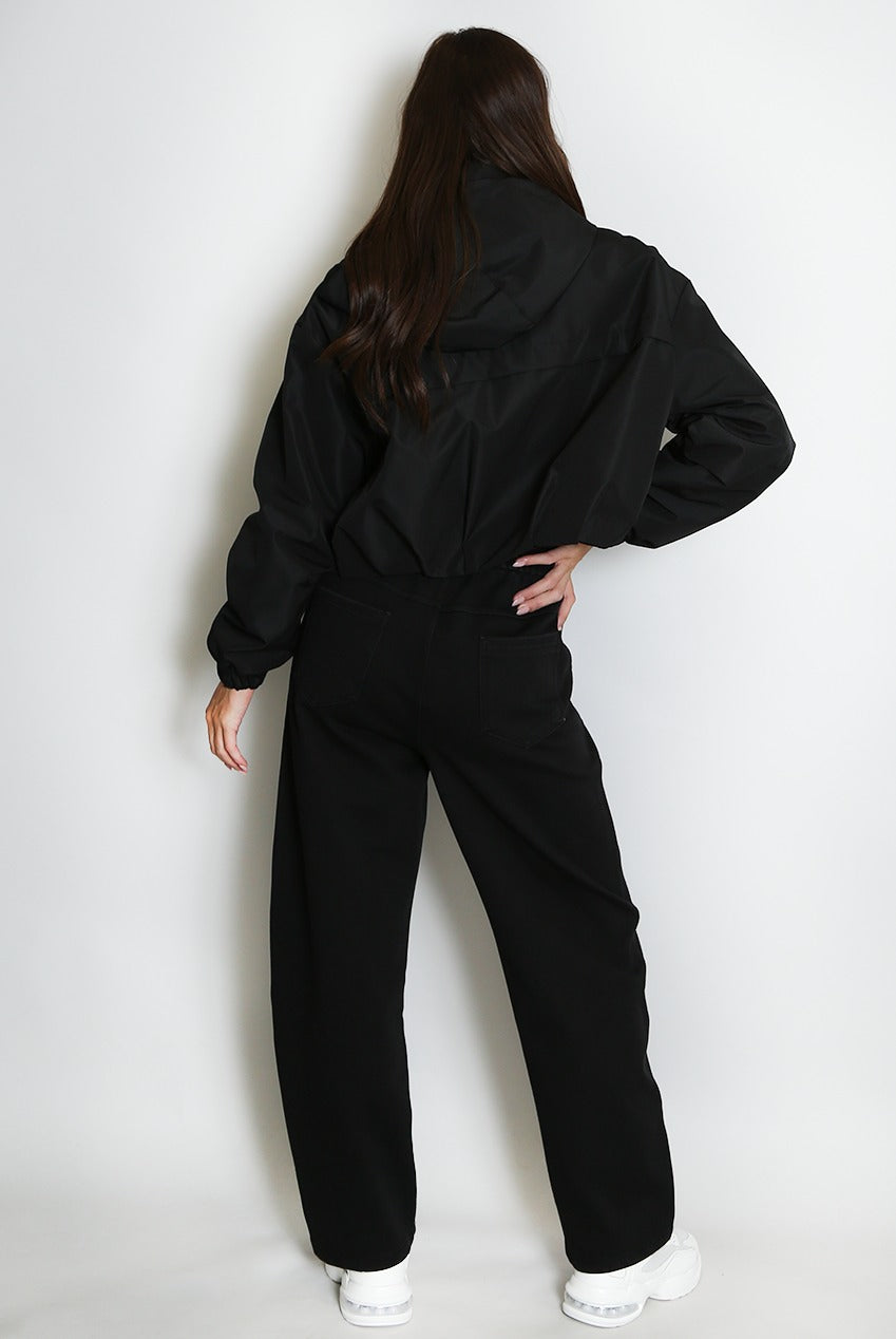 Black cropped hooded jacket from the back with gathered waist and zipper