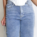 Embellished straight-leg jeans in light blue with silver speckle, front pockets close-up