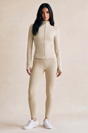 Beige zip-up athleisure jacket and matching leggings gym set