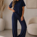 Side-cinched flared trousers set in navy, short-sleeve tee with matching flared pants