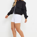 Black pocket bomber jacket with button front and flap pockets, casual street style