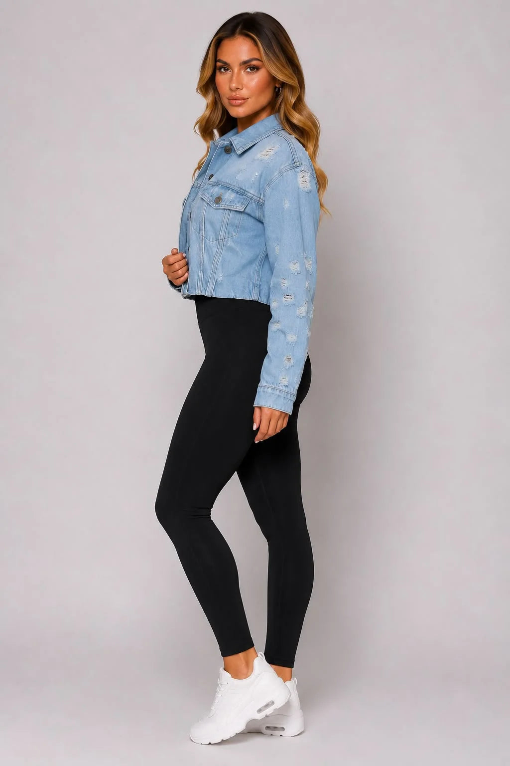 Light blue cropped distressed denim jacket side view with button front and long sleeves