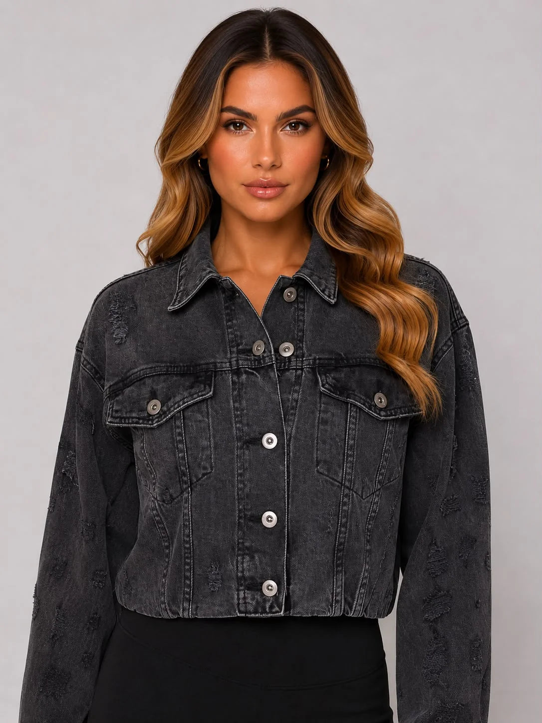 Dark gray cropped denim jacket with button front, flap chest pockets, and distressing