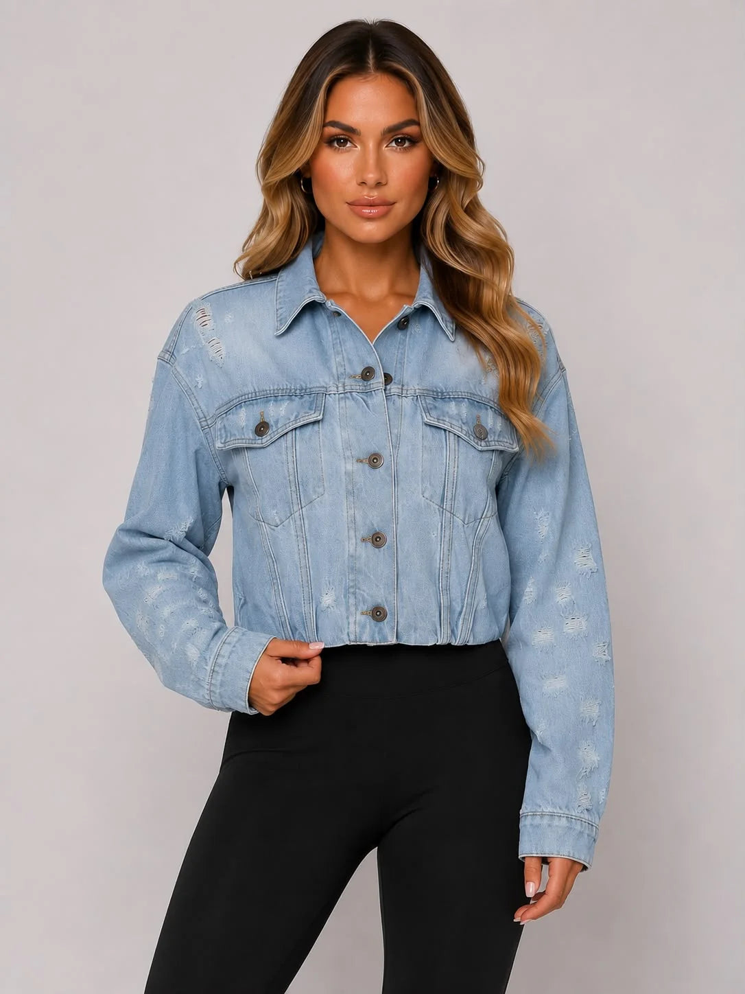 Light blue cropped distressed denim jacket with button front and flap chest pockets