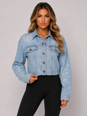 Light blue cropped distressed denim jacket with button front and flap chest pockets