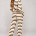 Beige and white striped long-sleeve top with matching wide-leg trousers