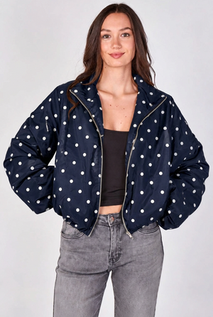 Navy lightweight jacket with white polka dots, zip front, and gathered cuffs