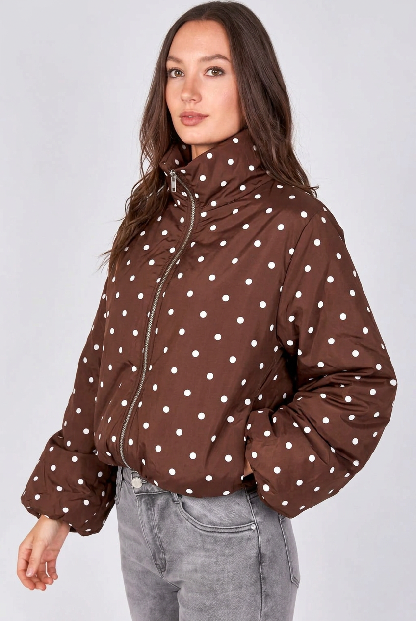 Brown lightweight jacket with white polka dots, high collar, zip front, and gathered cuffs