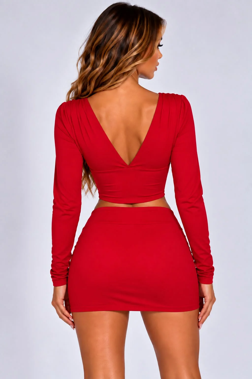 Red plunge-back long-sleeve crop top with mini skirt co-ord set, back view