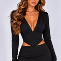 Black plunge-neck long-sleeve top and mini skirt co-ord set, close-up