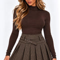 Brown houndstooth pleated mini skirt with belt and front buckle