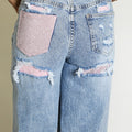 Straight-leg jeans in light blue denim with pink diamante pocket insert and rips