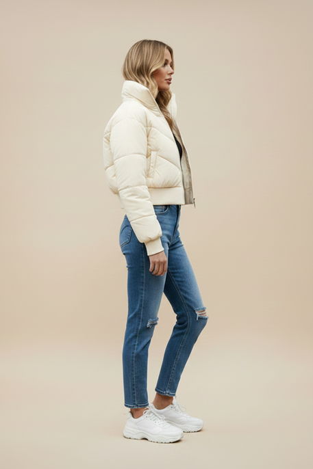 Light cream quilted puffer jacket with hood, front zipper, and elastic cuffs.