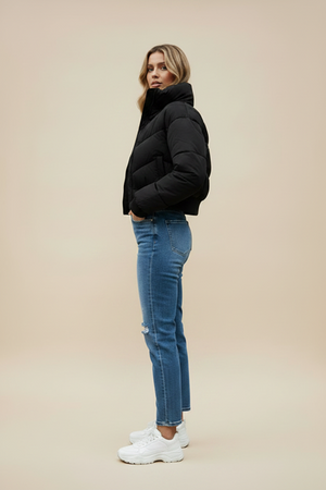 Black quilted puffer jacket with hood and front zipper; side profile view.
