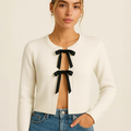 Light grey knitted lace-up cardigan with black bow ties at center front, long sleeves