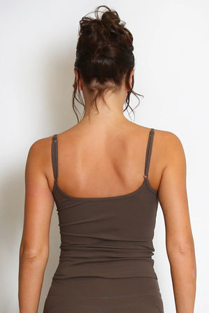 Back view: dark cami gym top with spaghetti straps and peplum hem