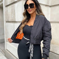 Black zip-up bomber jacket with front zipper and two flap pockets, model front view