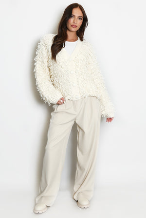 Cream loop-knit cardigan with V-neck, button front, shaggy fringe loops, long sleeves