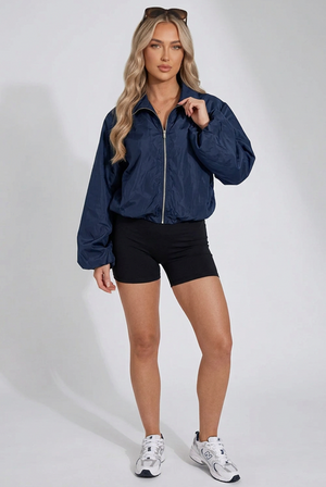 Navy windbreaker jacket with front zipper, stand collar, and elastic cuffs