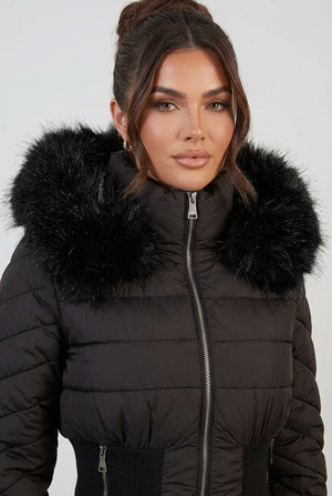 Black puffer jacket close-up with faux-fur hood trim and zipper